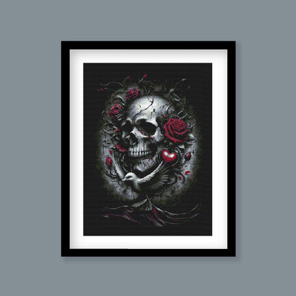 Gothic Skull and Roses Cross Stitch Pattern displayed as framed wall art with a dark skull, red rose detail, and dramatic gothic styling.