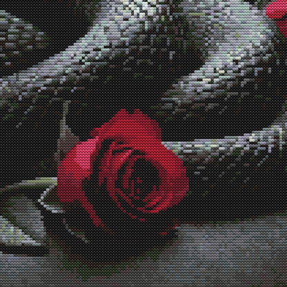 Gothic snake cross stitch pattern with a dark serpent design, red roses, and bold moody embroidery style.