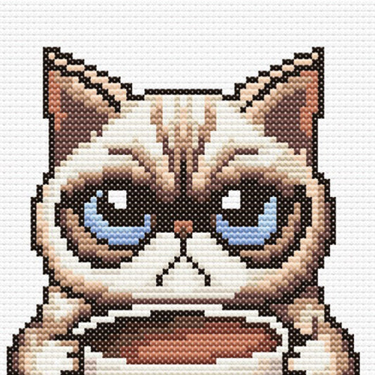 Close-up of Grumpy Cat Morning Coffee Cross Stitch Pattern showing the cat face, tired expression, coffee cup, and visible counted cross stitch texture.