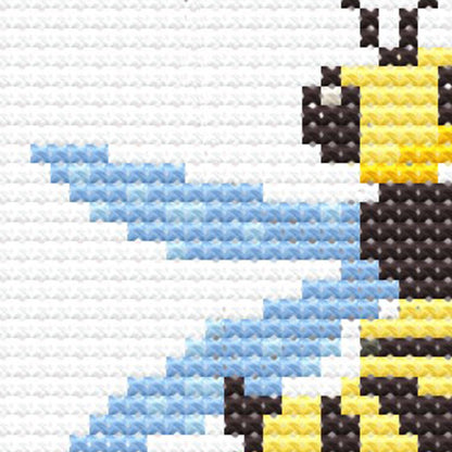 Close-up of Insect Cross Stitch Pattern Set showing a bee with blue wings, yellow stripes, and visible counted cross stitch texture.