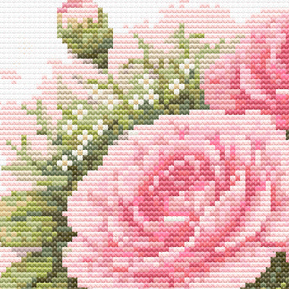 Close up of pink carnation cross stitch pattern showing detailed stitches and shading in floral embroidery