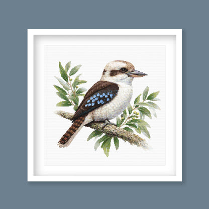 Kookaburra Cross Stitch Pattern displayed as framed wall art with a native Australian kookaburra, eucalyptus leaves, and soft natural bird detail.