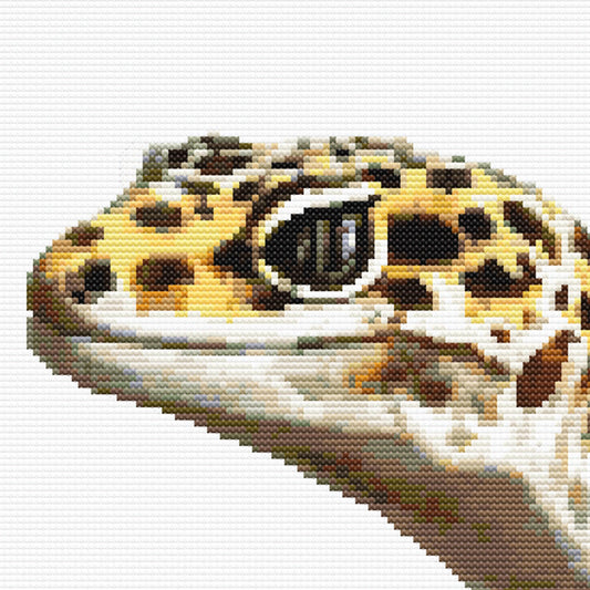 Close-up of Leopard Gecko Cross Stitch Pattern featuring the gecko face, spotted markings, eye detail, and visible stitch texture.