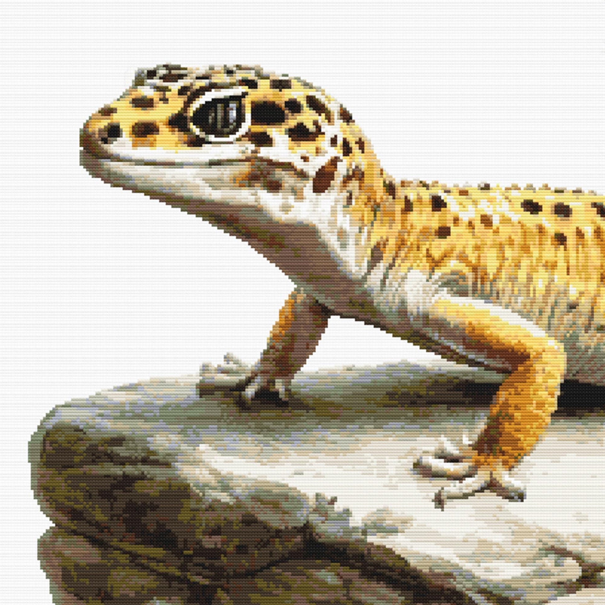 Leopard Gecko Cross Stitch Pattern featuring a spotted gecko on a rock ledge with natural reptile detail and wildlife-inspired style.