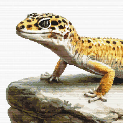 Leopard Gecko Cross Stitch Pattern featuring a spotted gecko on a rock ledge with natural reptile detail and wildlife-inspired style.