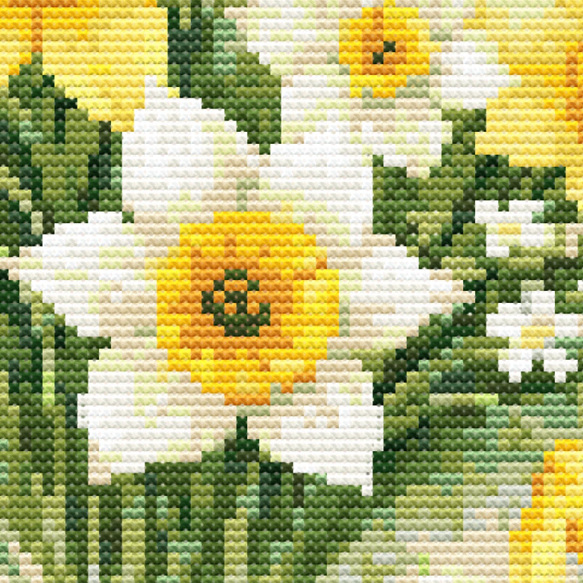 Close-up of March Birth Flower Cross Stitch Pattern showing daffodil petals, green foliage, soft yellow tones, and counted cross stitch detail.