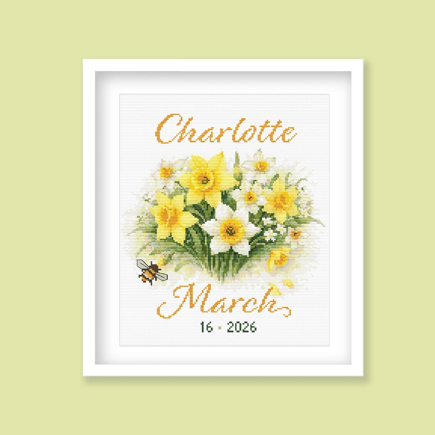 March Birth Flower Cross Stitch Pattern displayed as framed personalised wall art with yellow daffodils, name, date, and soft floral detail.