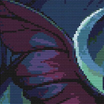 Close-up of Mothman Cross Stitch Pattern showing dark purple wings, moonlit background, and visible counted cross stitch texture.