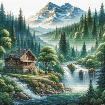 Mountain Cabin Retreat cross stitch pattern featuring a mountain cabin with waterfalls and pine forest scenery.