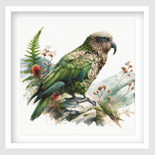 New Zealand Kea Cross Stitch Pattern displayed as framed wall art with a native alpine parrot, green feathers, mountain foliage, and natural New Zealand bird detail.