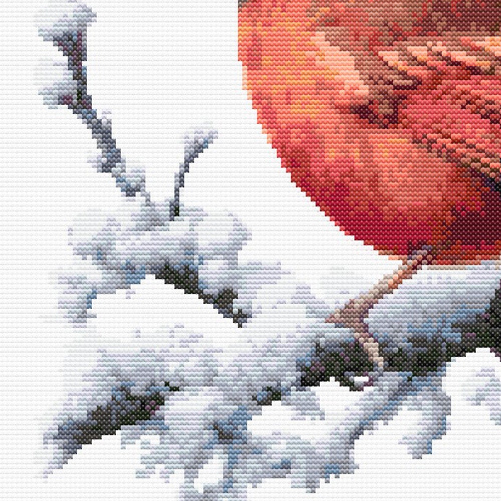 Northern Cardinal Bird Cross Stitch Pattern featuring a bright red cardinal perched on snow-covered branches in a winter wildlife design.