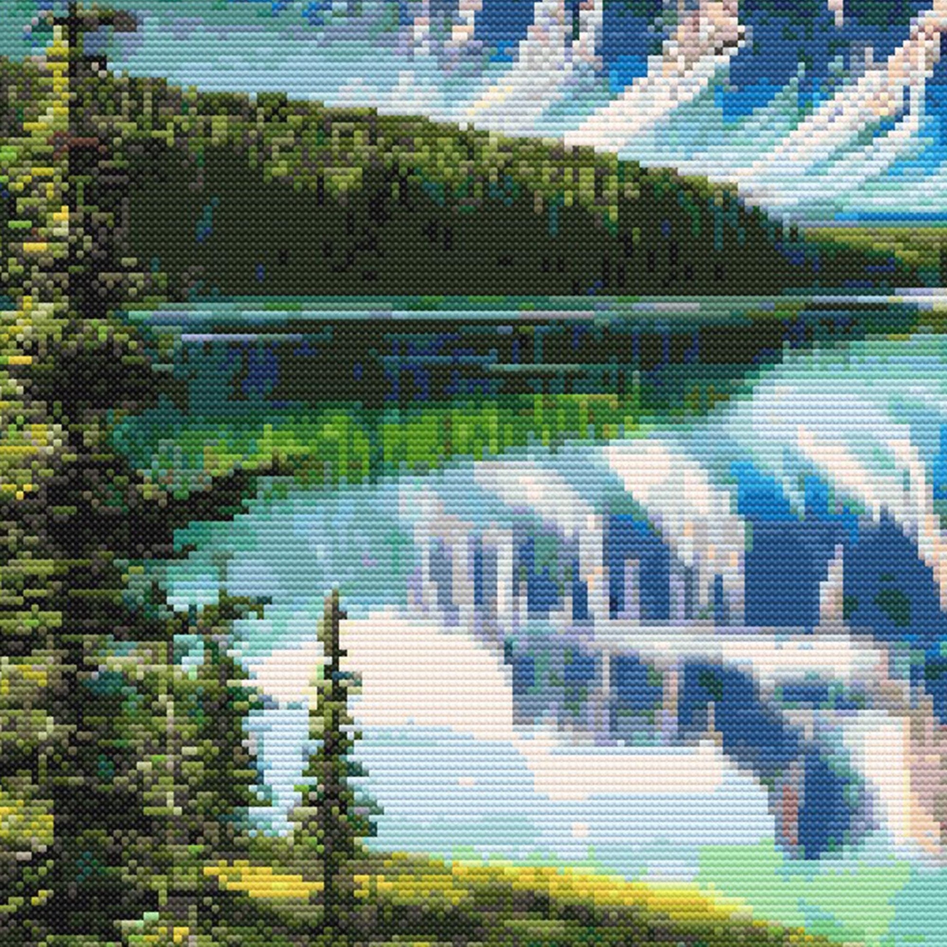 Moose cross stitch pattern close-up featuring a reflective mountain lake, pine forest, snowy peaks, and bright northern landscape detail.