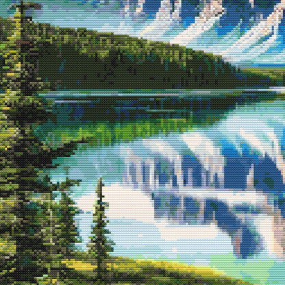 Moose cross stitch pattern close-up featuring a reflective mountain lake, pine forest, snowy peaks, and bright northern landscape detail.