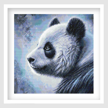 Panda cross stitch pattern featuring a detailed blue-toned panda portrait with soft shading, textured fur and an abstract wildlife background.
