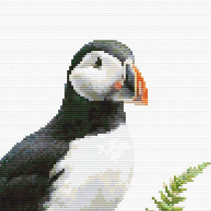 Close-up of Puffin Cross Stitch Pattern showing the puffin’s face, black-and-white markings, orange beak, and soft bird detail.