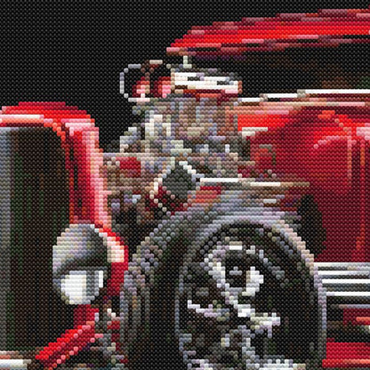 Close-up of Red Hot Rod Cross Stitch Pattern showing the exposed engine, front wheel, chrome detail, and classic hot rod styling.