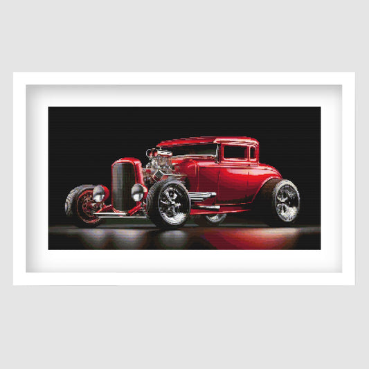 Red Hot Rod Cross Stitch Pattern displayed as framed wall art with a glossy red classic car, black background, chrome detail, and retro automotive styling.