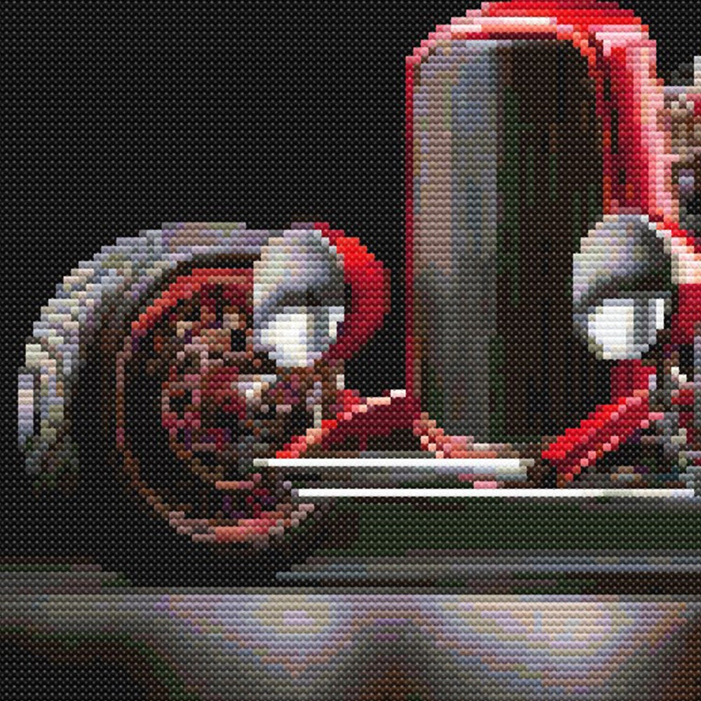 Close-up of Red Hot Rod Cross Stitch Pattern showing the wheel, chrome reflection, red bodywork, and dramatic black background.