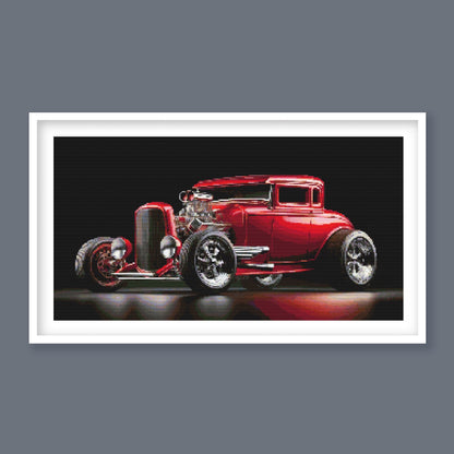 Red Hot Rod Cross Stitch Pattern displayed in a white frame as retro car wall art with a red hot rod and black background.