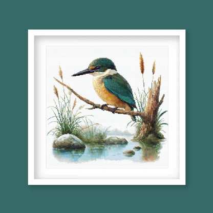 Sacred Kingfisher Kōtare Cross Stitch Pattern displayed in a green frame as native New Zealand bird wall art with wetland-inspired detail.