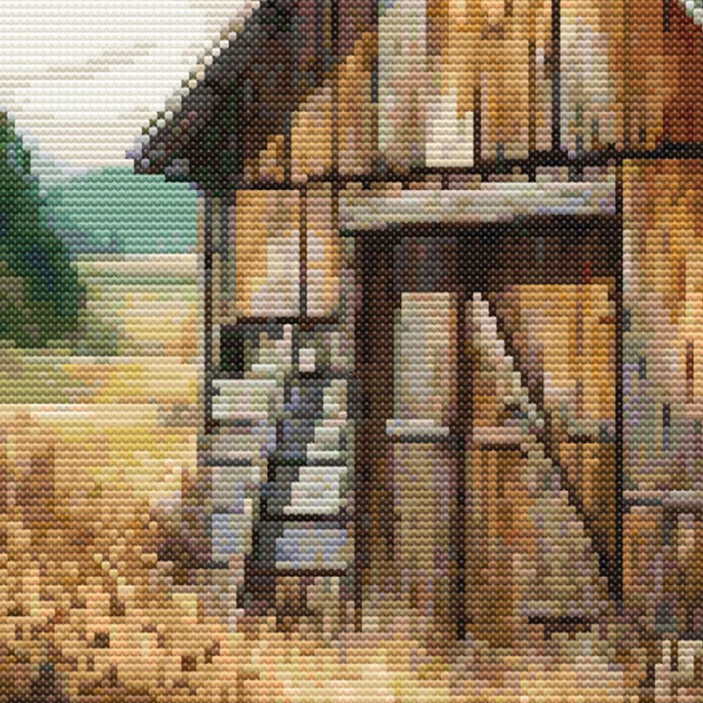 Close up of a rustic barn and green trees in the backgound, the barn door is closed.