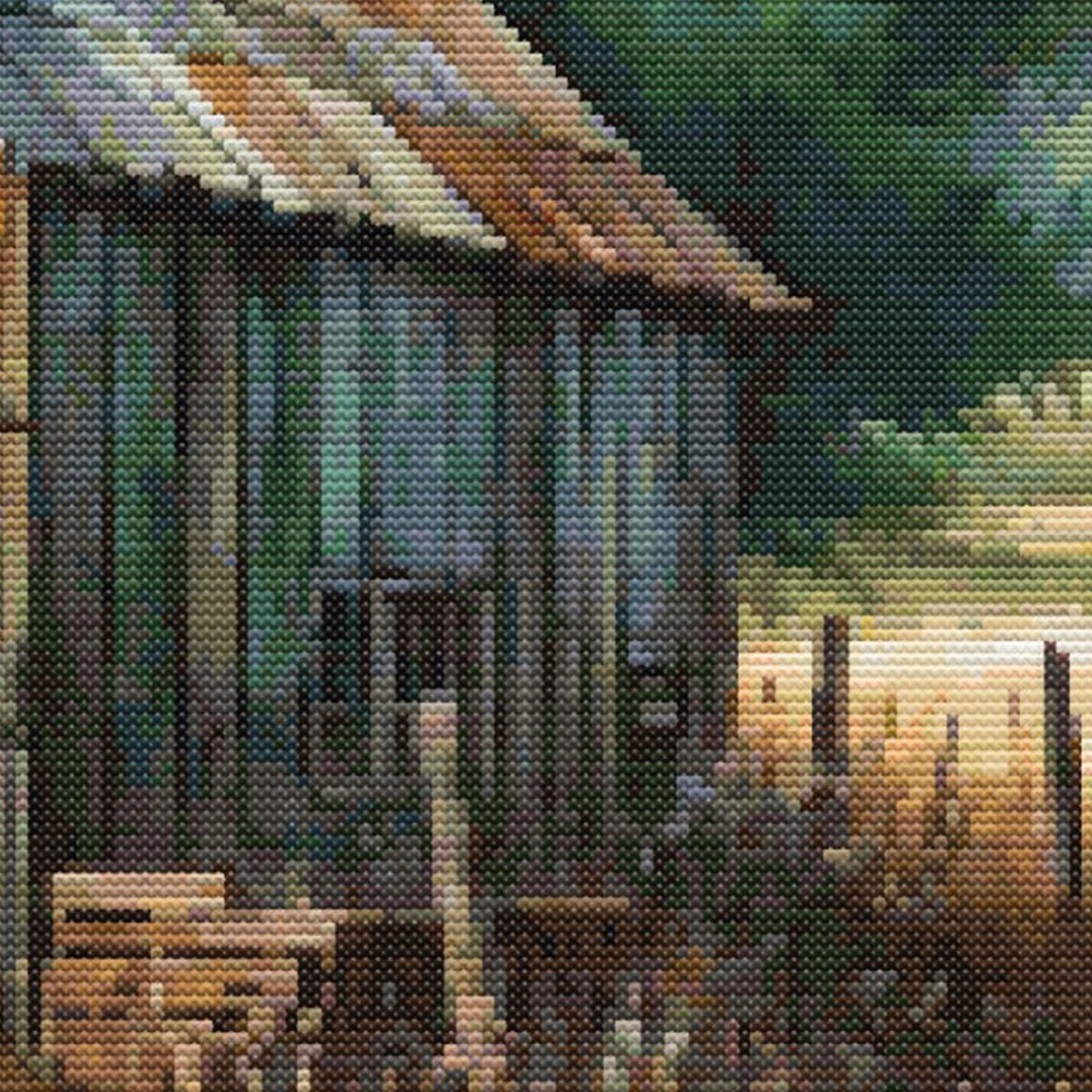 A side angle of the Rustic Barn Cross Stitch Pattern showing a stack of wood and a window.