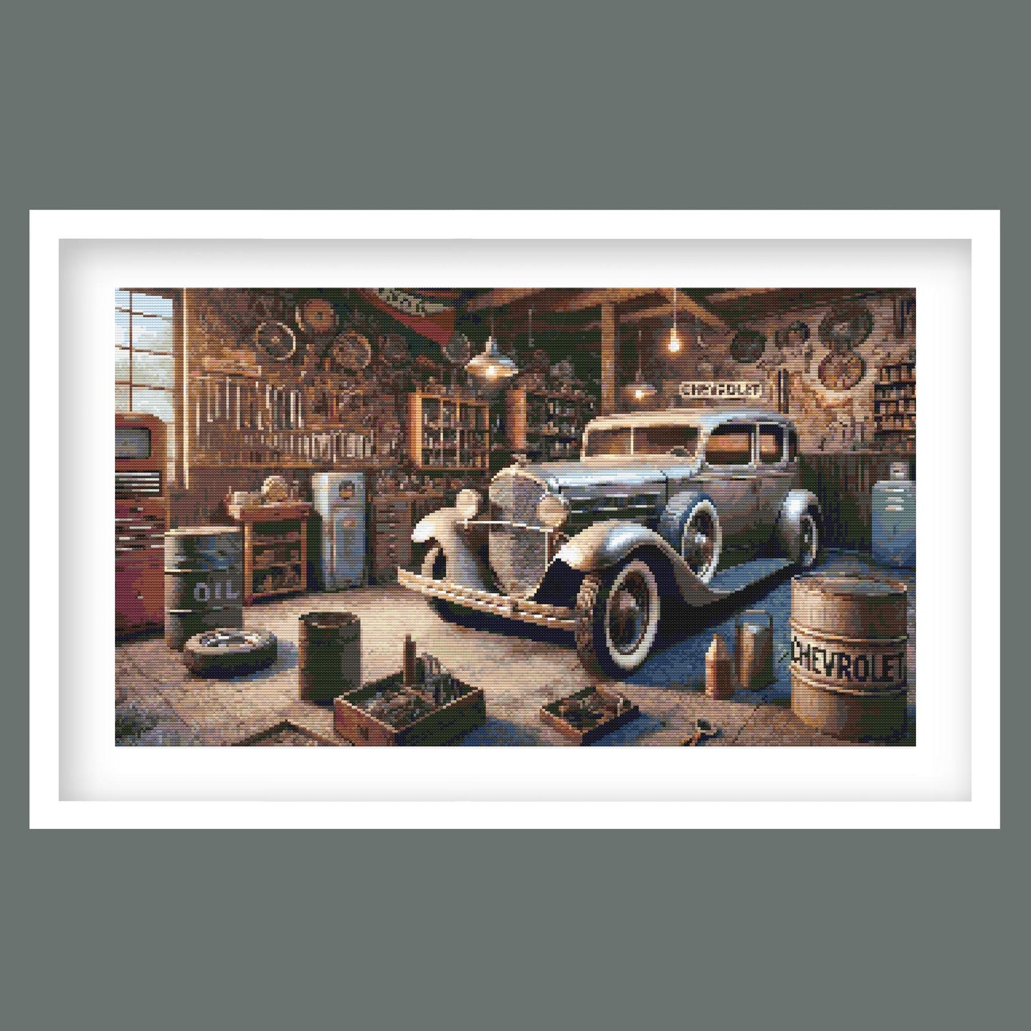Vintage Garage Cross Stitch Pattern displayed in a black frame as retro vehicle wall art with a classic car and old garage setting.