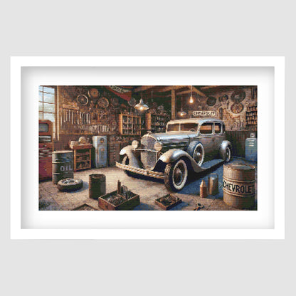 Vintage Garage Cross Stitch Pattern displayed as framed wall art with a classic car, old workshop tools, oil cans, and retro garage detail.