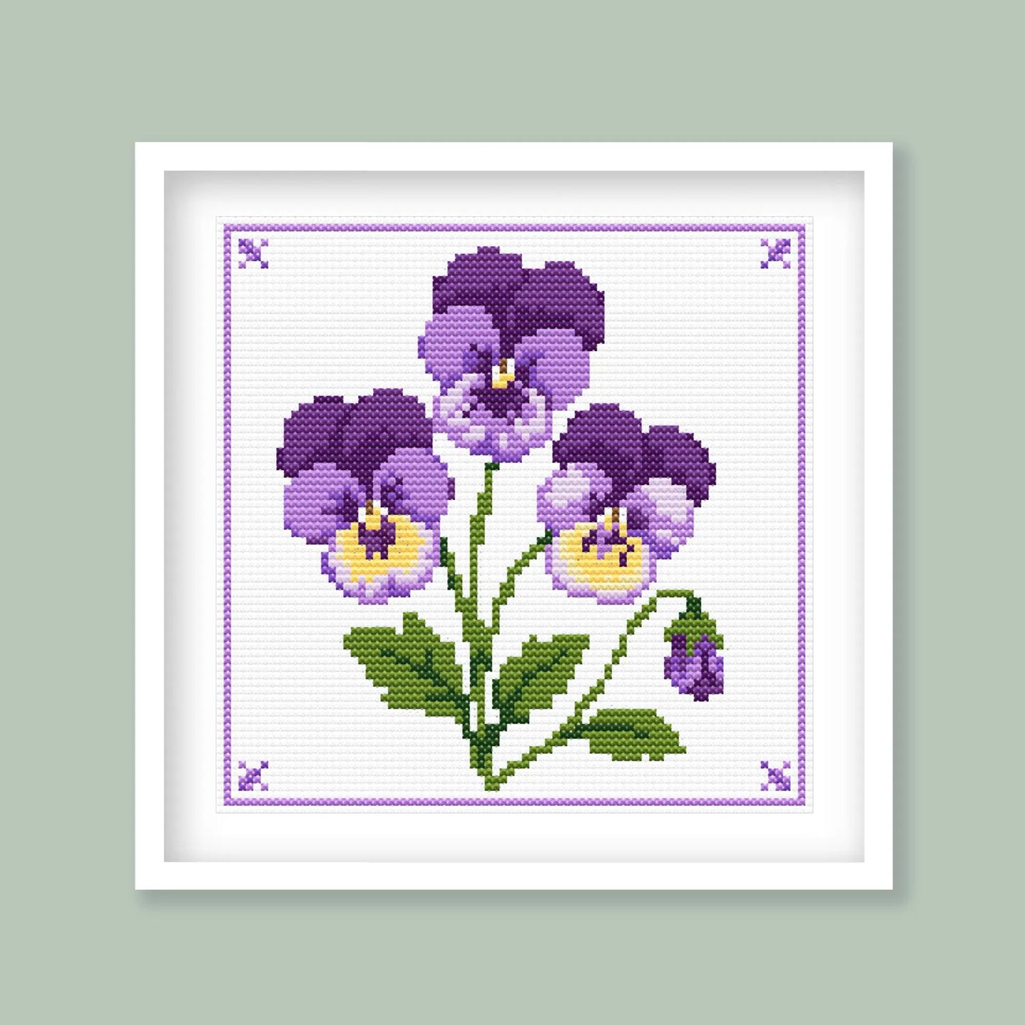 Viola cross stitch pattern featuring purple and yellow flowers with green leaves and a decorative purple stitched border.