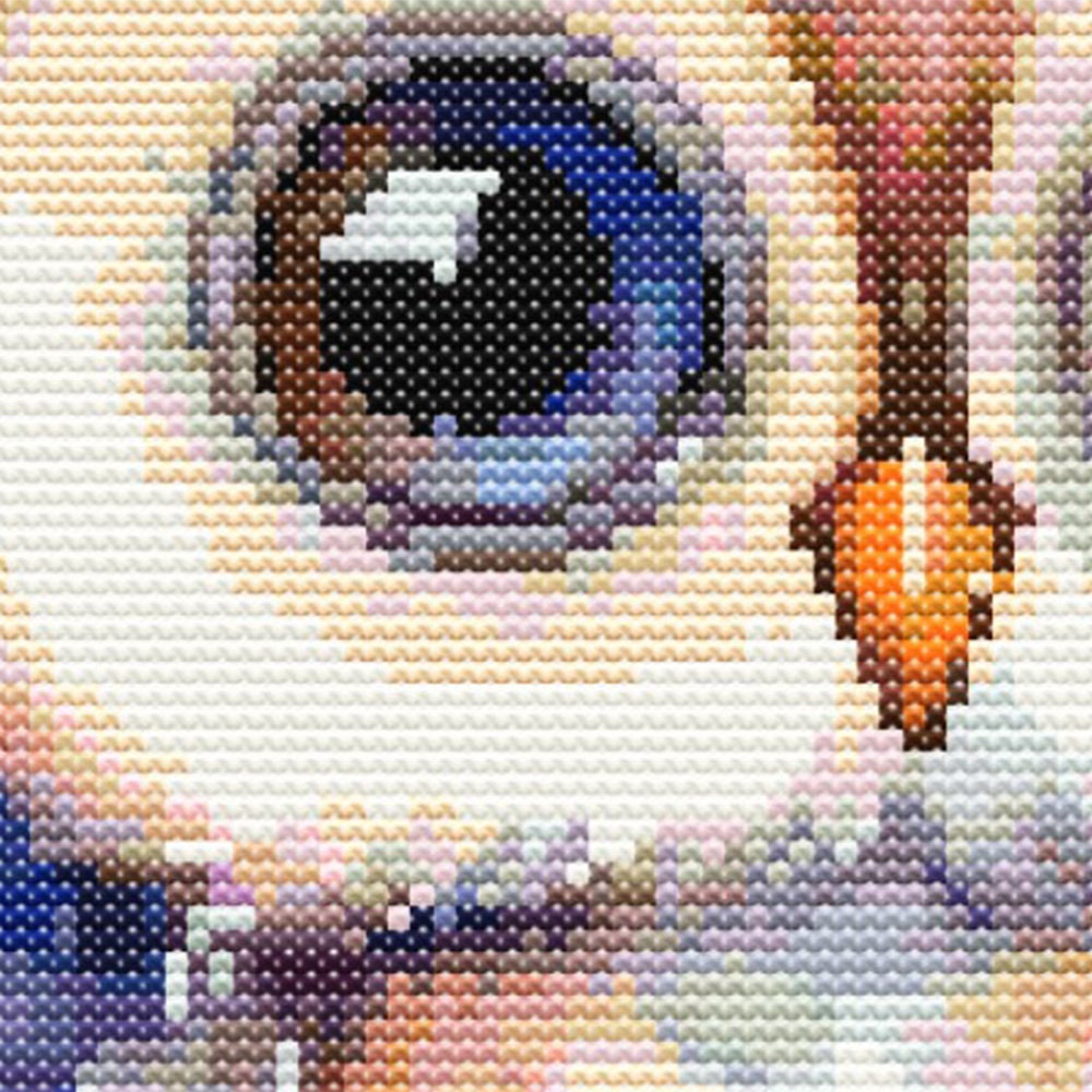 Close-up of Whimsical Owl Cross Stitch Pattern showing the owl eye, feather detail, soft colour shading, and visible counted cross stitch texture.