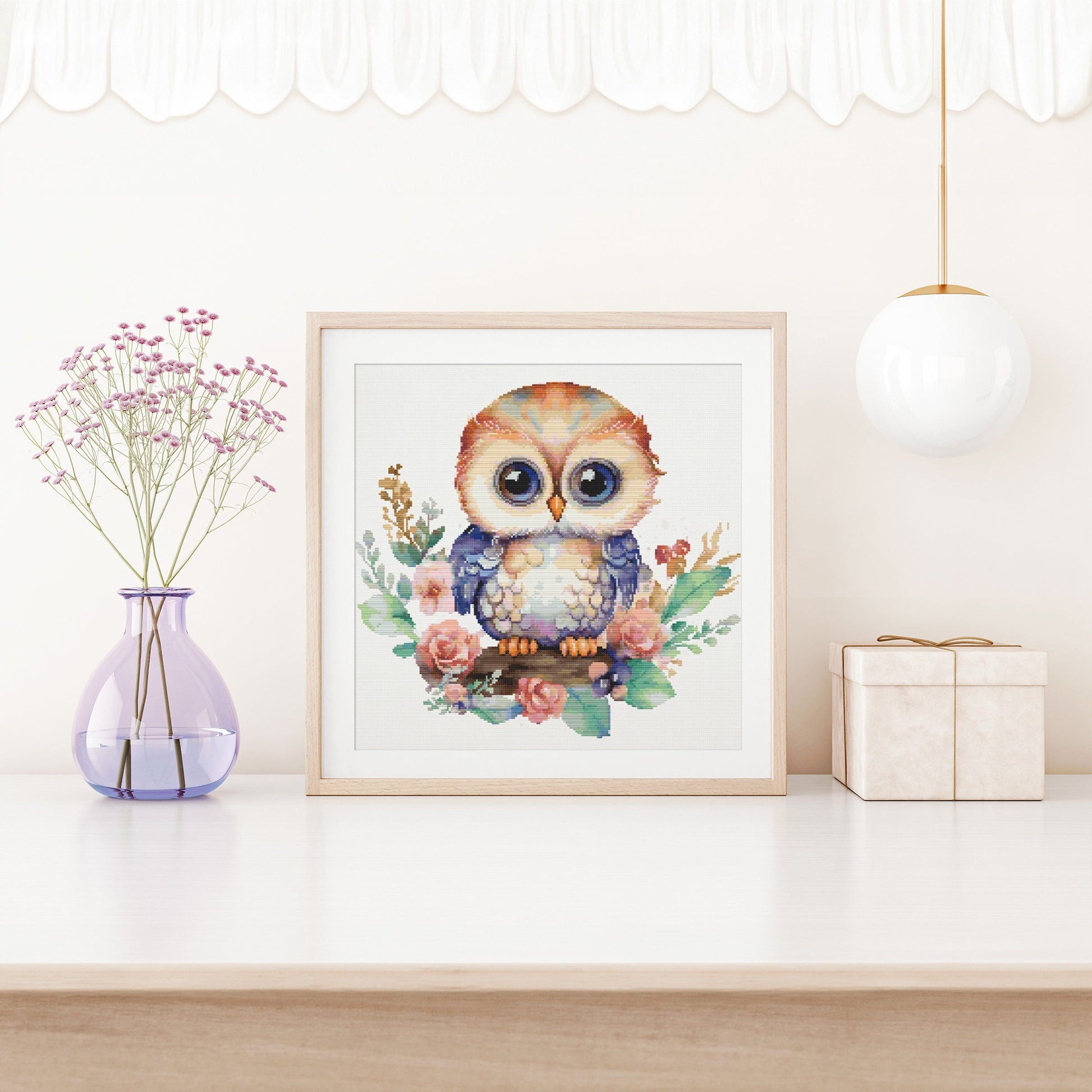 Whimsical Owl Cross Stitch Pattern shown in a nursery-style room with soft decor, pastel colours, and children’s wall art styling.