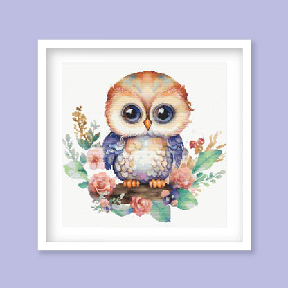 Whimsical Owl Cross Stitch Pattern displayed as framed wall art with a cute owl, floral detail, soft colours, and nursery-style decor.