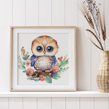 Whimsical Owl Cross Stitch Pattern shown in a room preview as soft owl wall art for a nursery, girls room, or children’s space.
