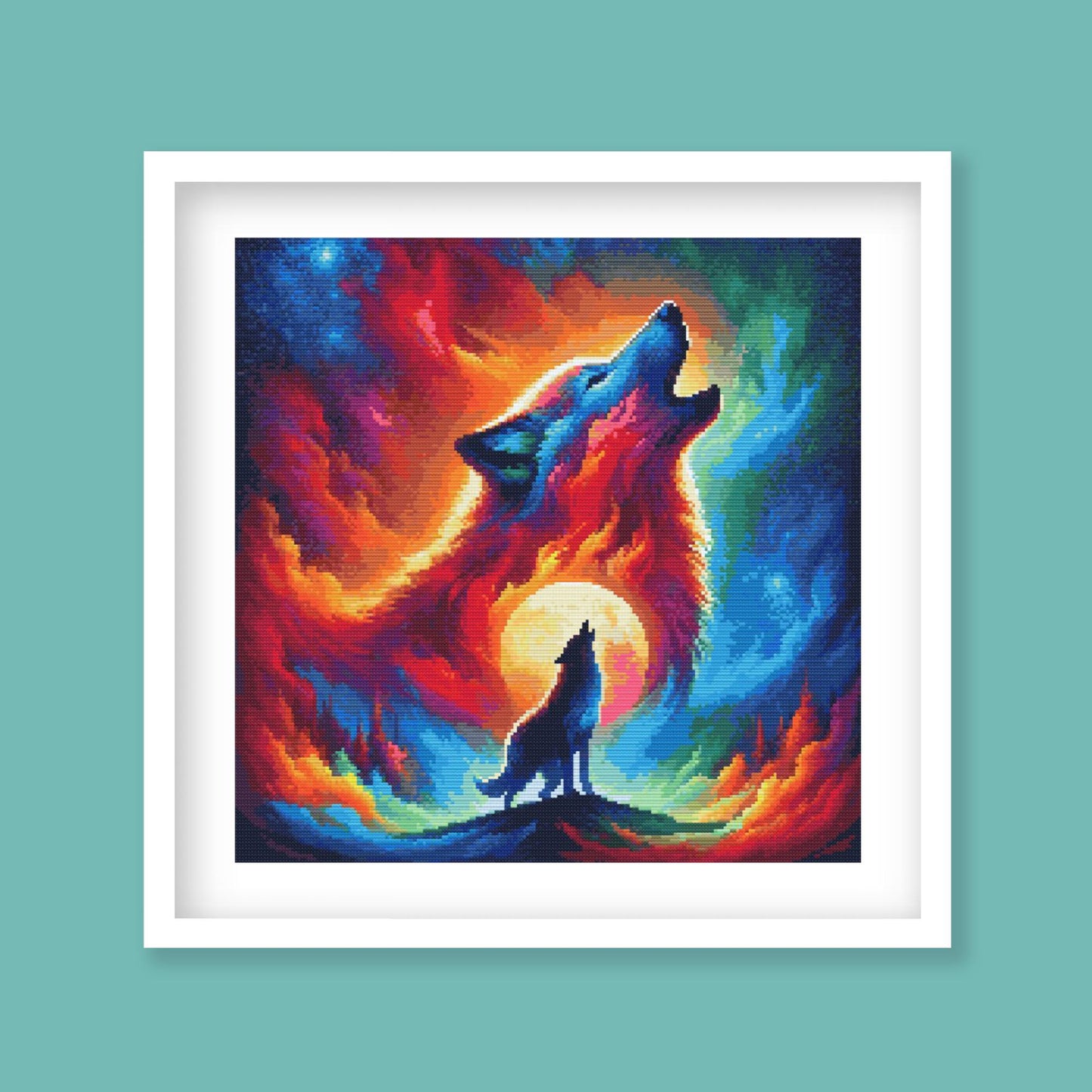 Wolf cross stitch pattern displayed in a black frame as bold wildlife wall art with a howling wolf and fiery sky.