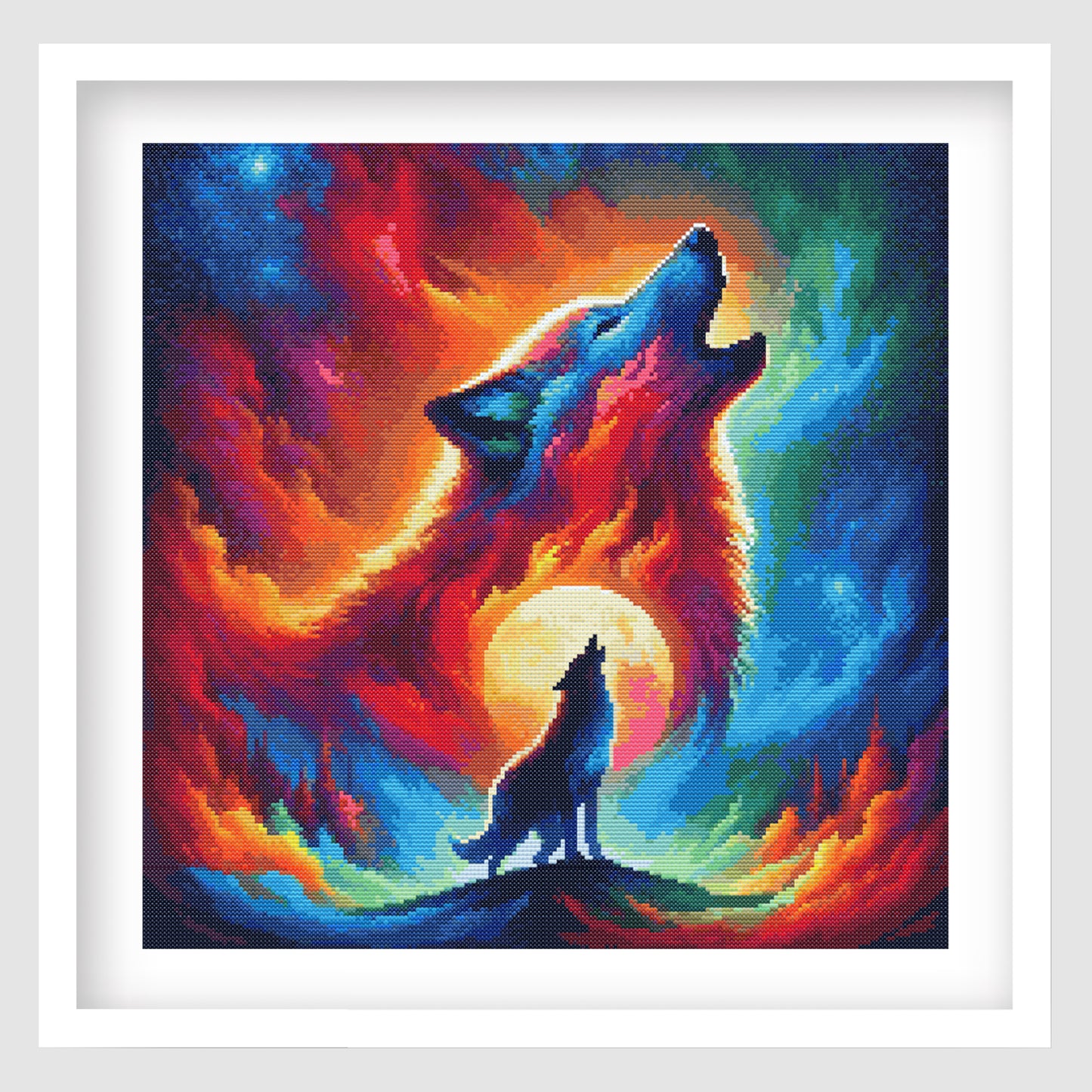 Wolf cross stitch pattern shown as framed wall art with a howling wolf, moonlit sky, fiery colours, and dramatic wildlife design.