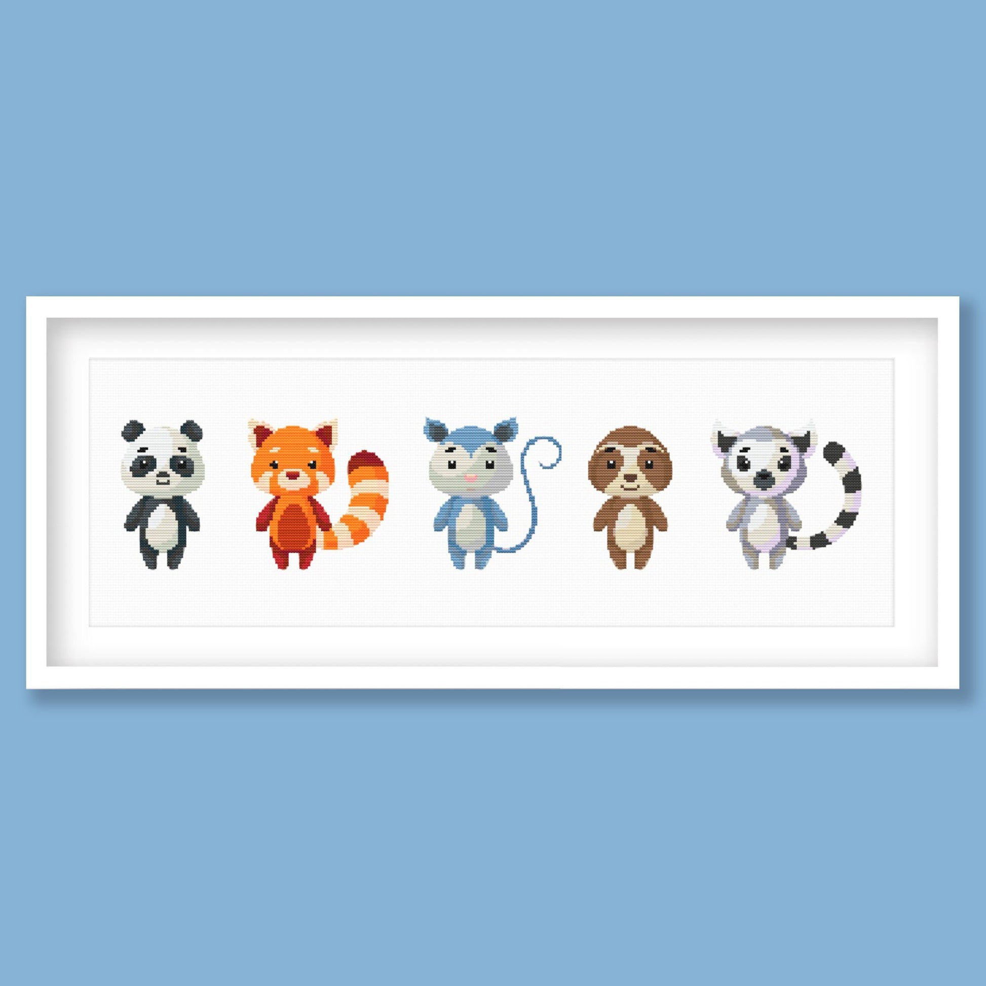 Cute Woodland Animal Cross Stitch Pattern displayed in a blue frame with a row of colourful animal characters for children’s room decor.