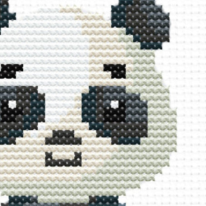 Close-up of Cute Woodland Animal Cross Stitch Pattern showing a panda design with soft colours and visible counted cross stitch texture.