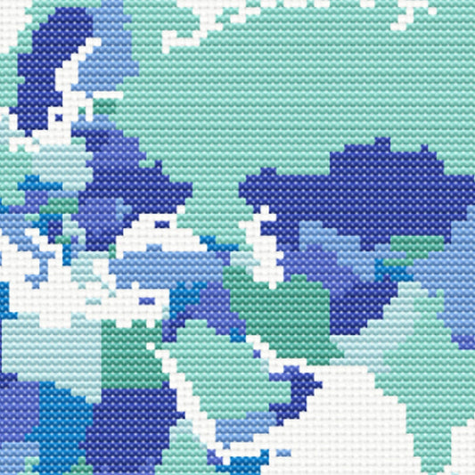 World Map Cross Stitch Pattern close-up showing blue and teal map detail, geographic shapes, and visible counted cross stitch texture.