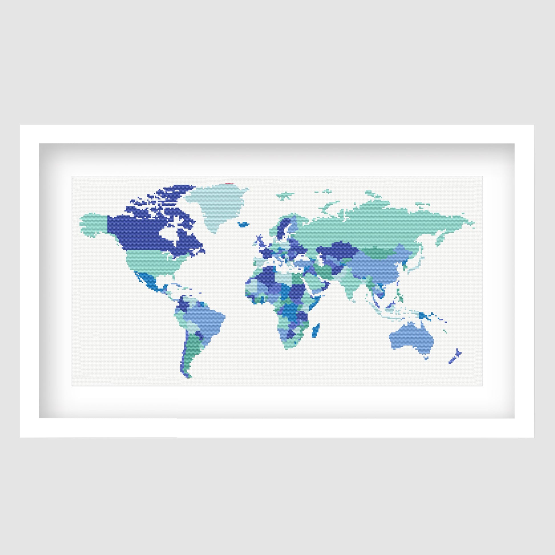 World Map Cross Stitch Pattern displayed as framed wall art with a blue and teal world map design for travel, classroom, or kids room decor.
